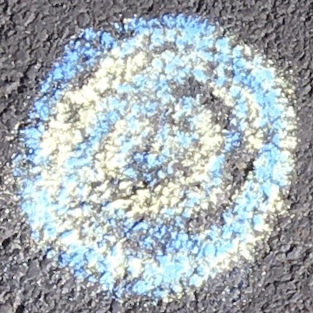 blue and yellow chalk dots on tarmac