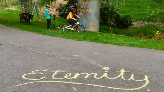 Example: Eternity, written in chalk, children in background