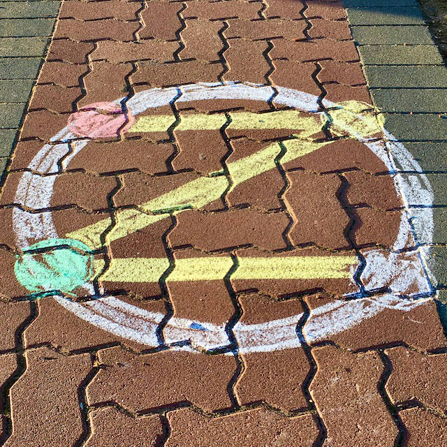 colourful dotZero symbol in chalk on pavers