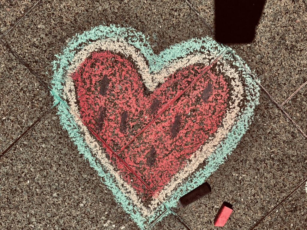 Love heart with watermelon centre, Palestinian flag colours. Pavement chalk nearly.